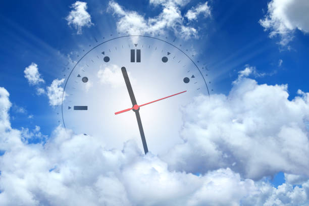 Conceptual Time Image Of Clock Face In Sunny Blue Sky With White Clouds