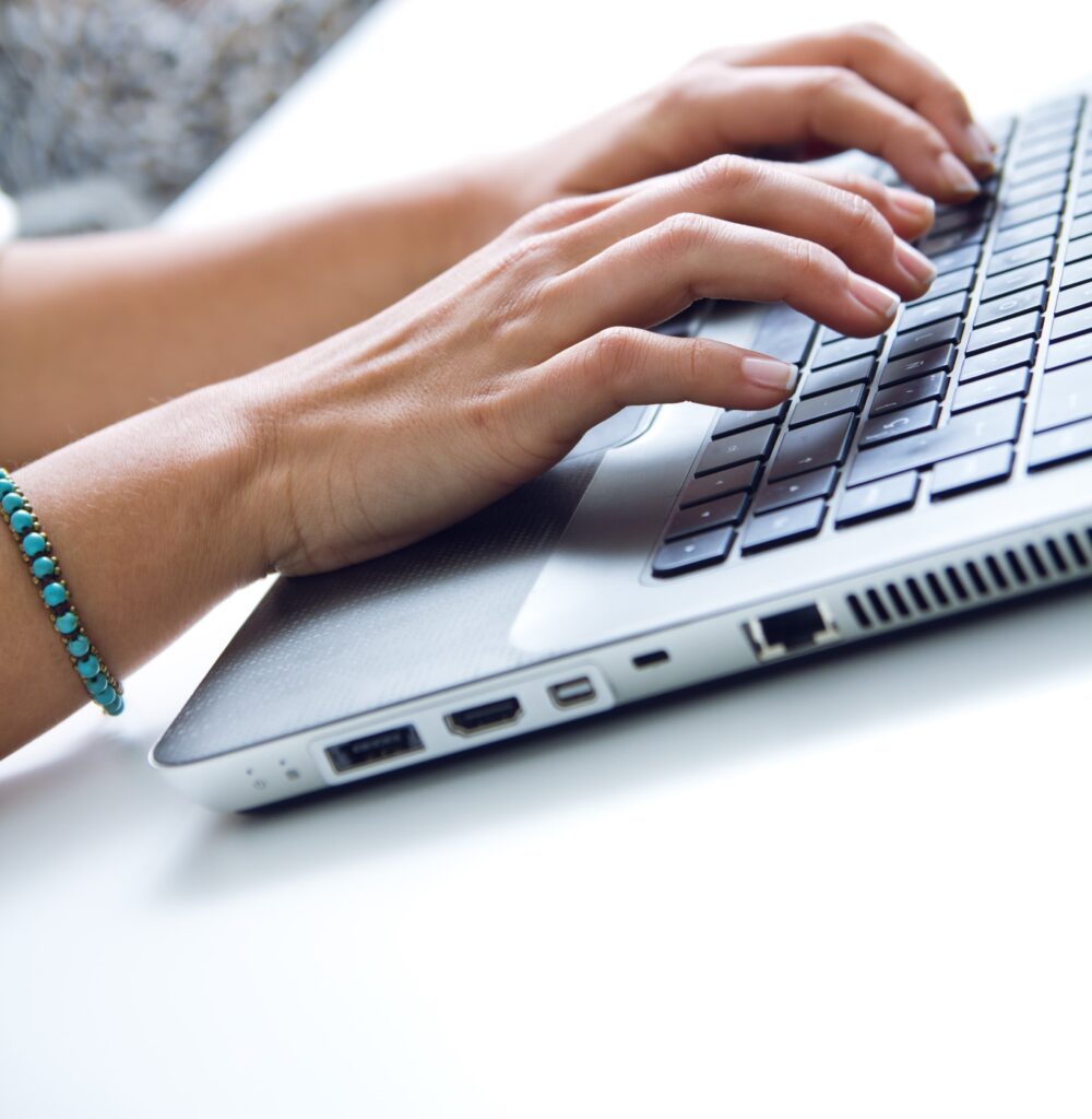 Woman Hands Typing On Laptop